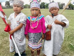 Three small Shipibo children in traditional wear.